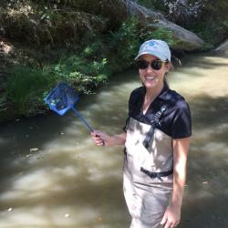 Fisheries Biologist Erin Seghesio holding a small net