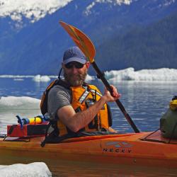 Photo of Jordan Watson kayaking.