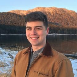 Photo of Andrew Steinkruger next to a lake.