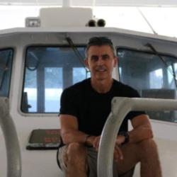 Dr. Enric Cortes on desk of vessel preparing for fieldwork.