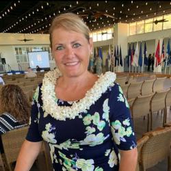Angela Strong smiling and wearing a lei.