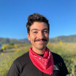 Michael Acquafredda, in field wearing black t-shirt with red bandana 