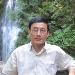Photo of Hongguang Ma in front of a waterfall