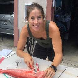 A photo of Eva Schemmel preparing a bottomfish for life history study