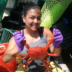 Stephanie Martinez smiling holding a crab