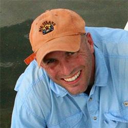 Man with orange hat smiling at camera