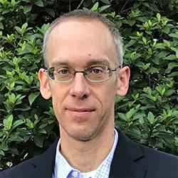 Portrait of scientist with green leaves in background