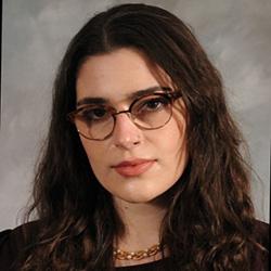 Portrait of scientist wearing glasses and dark shirt
