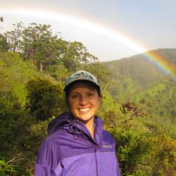 Yvonne Barkley with a stunning Hawaiian rainbow and forest backdrop. 