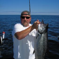 Doug Limpinsel on a boat holding up a large fish