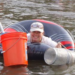 Heather Soulen in inner tube with collection nets and bucket.