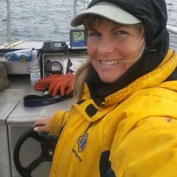 Kim Raum-Suryan steering a boat