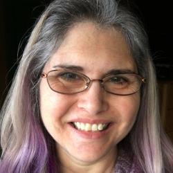 Scientist with glasses and purple streaks in hair