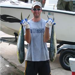 Mike Morin holding a fish in each hand.