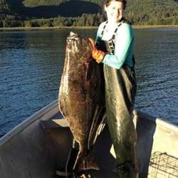 Stephanie Warpinski in a boat holding a very big fish