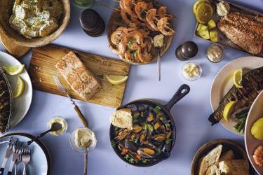 A table with a variety of fish and shellfish dishes