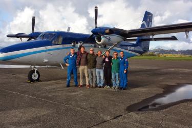 A NOAA aerial survey crew gathers in front of a NOAA Twin Otter aircraft during a stop in Astoria, Oregon.