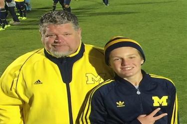 Brent Stoffle enjoying a University of Michigan soccer game with his son. 