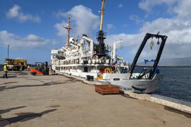 NOAA ship Rainier is docked at a concrete pier