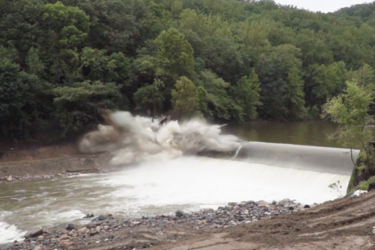 An explosion breaches the Bloede Dam on the Patapsco River, Maryland. Dam removal is an effective tool to reconnect river herring to historical spawning habitats.