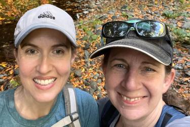 Two women looking up and smiling at the camera