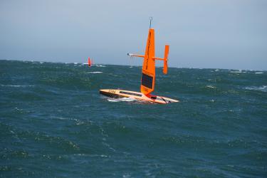 Orange sail drone at sea