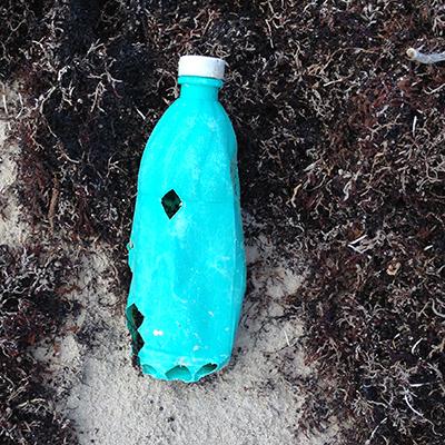 A single-use plastic bottle found along Texas' shoreline with sea turtle bite markings