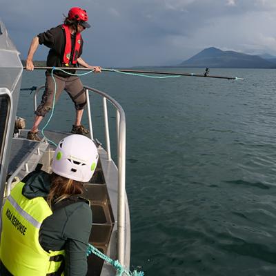 A team member waiting for the right opportunity to make strategic cuts to gear using specialized cutting equipment. Credit: David Gann (NMFS Permit # 24359)