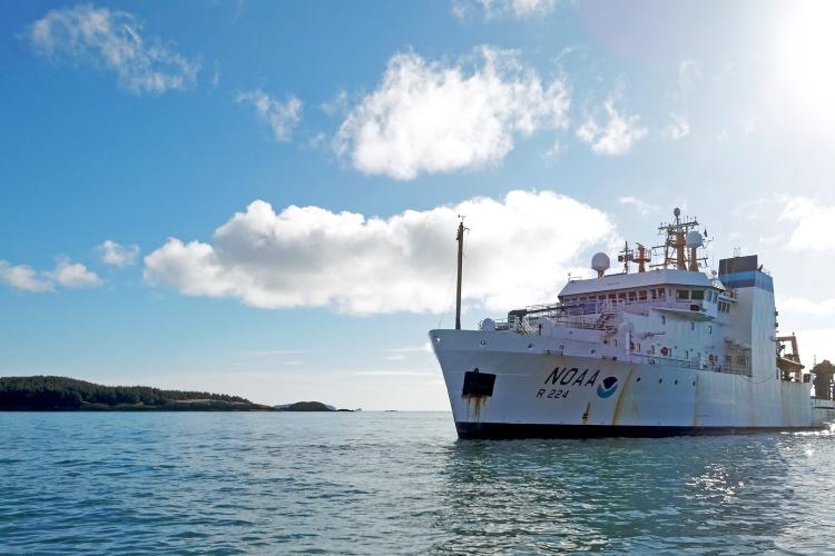 NOAA Ship Oscar Dyson on water with blue sky in the background