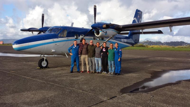 A NOAA aerial survey crew gathers in front of a NOAA Twin Otter aircraft during a stop in Astoria, Oregon.