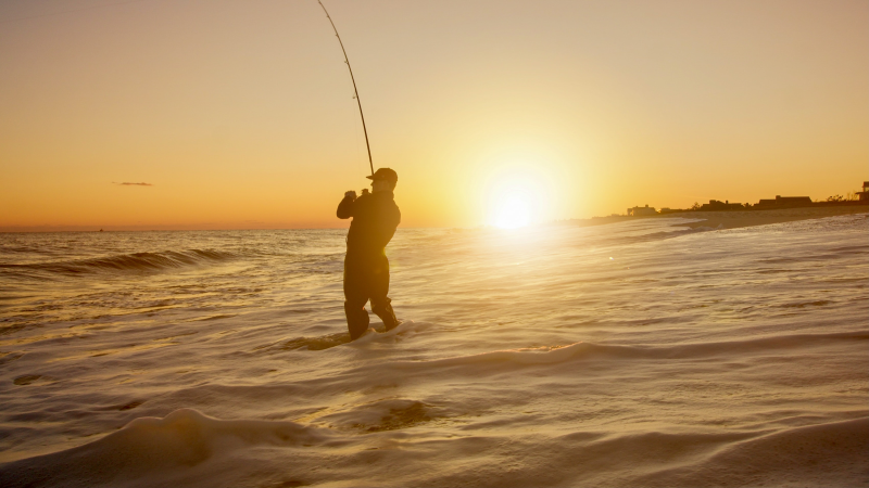 Surfaster in waves at sunrise.