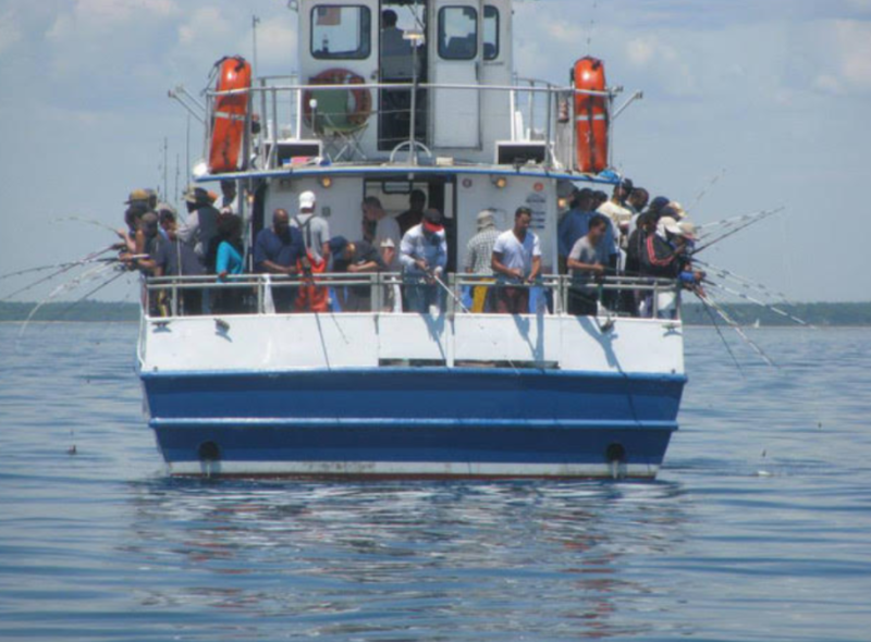 Picture of people fishing off of the boat