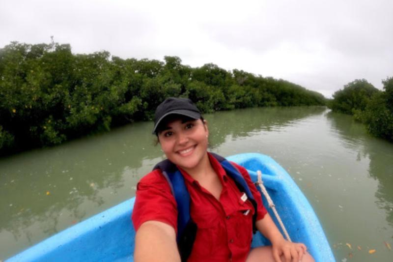 Elena Flores sitting in a kayak visiting mangrove sites in Tamaulipas, Mexico.  