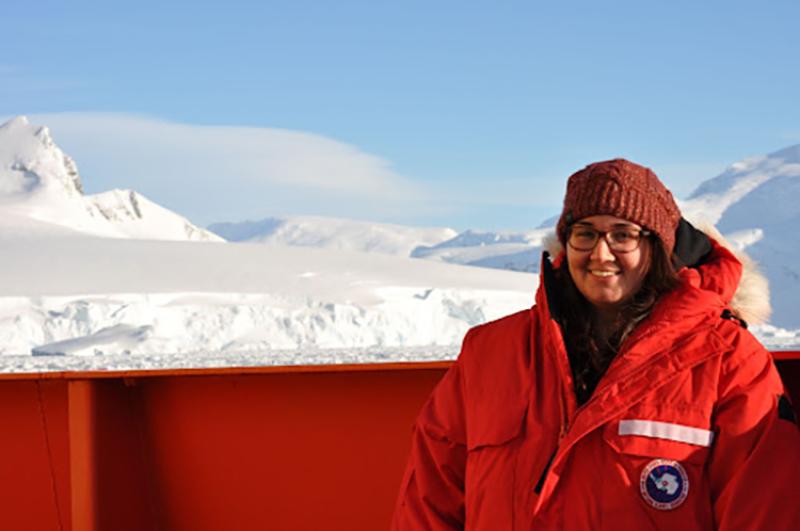 Zuzy Abdala stands in front of a glacier while conducting research in Antartica