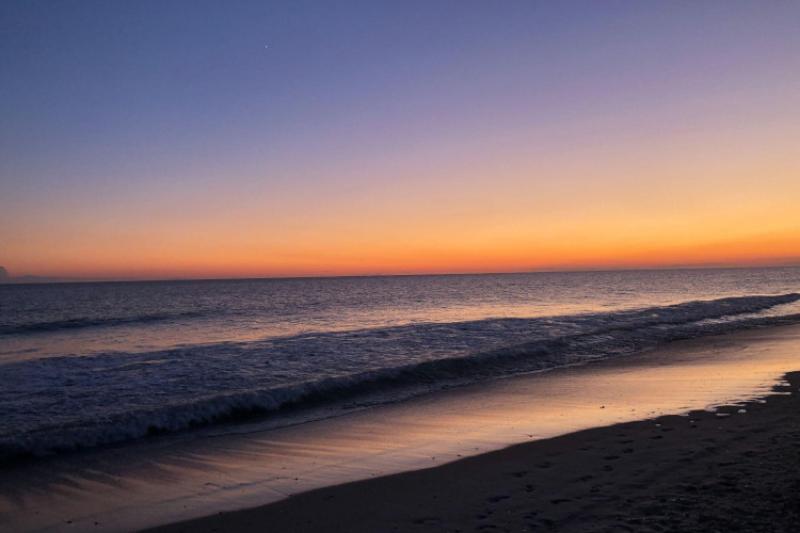 The sun setting over the ocean.