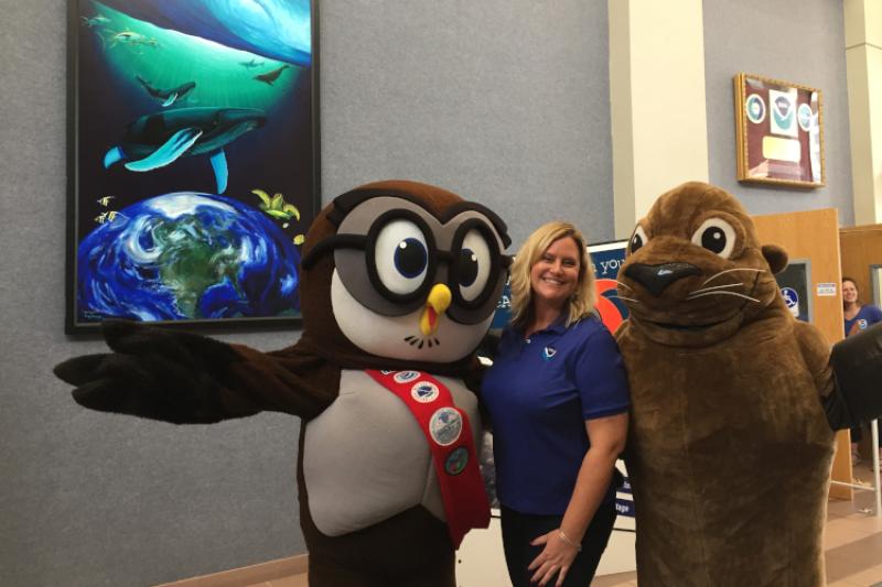 Image of keeley Belva with NOAA's two mascots.