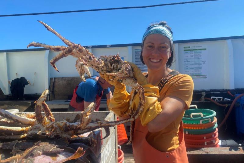 Erin Fedewa holds up a crab while on a survey. Credit: NOAA Fisheries