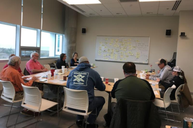 Participants in Wanchese, North Carolina help NOAA scientists understand how dolphinfish and wahoo fisheries function in their region by creating a conceptual model from sticky notes.