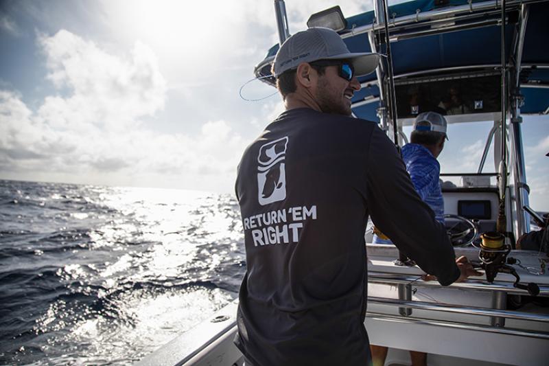 Person on a boat wearing a Return Em Right tee shirt