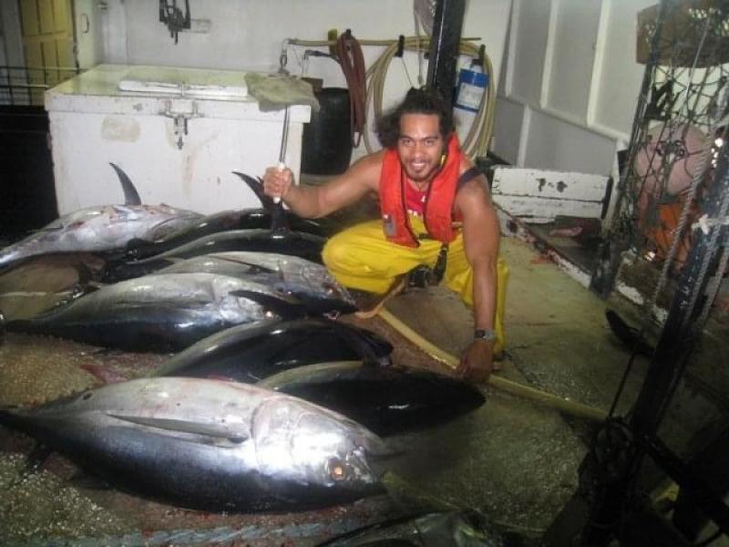 Esera examines some bigeye tuna