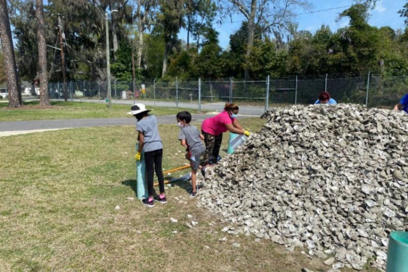 Volunteers bagging oyster cultch, a substrate that helps oysters grow, at the Savannah State University Marine Science Research Center.