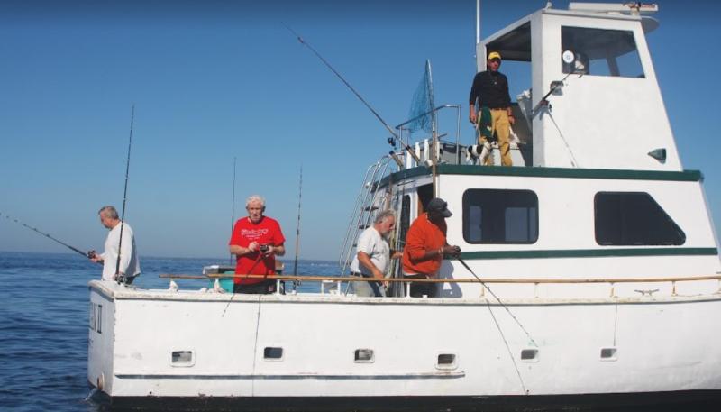 Five recreational anglers fishing on a boat