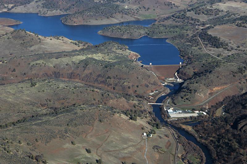 Aerial view of a large dam and reservoir