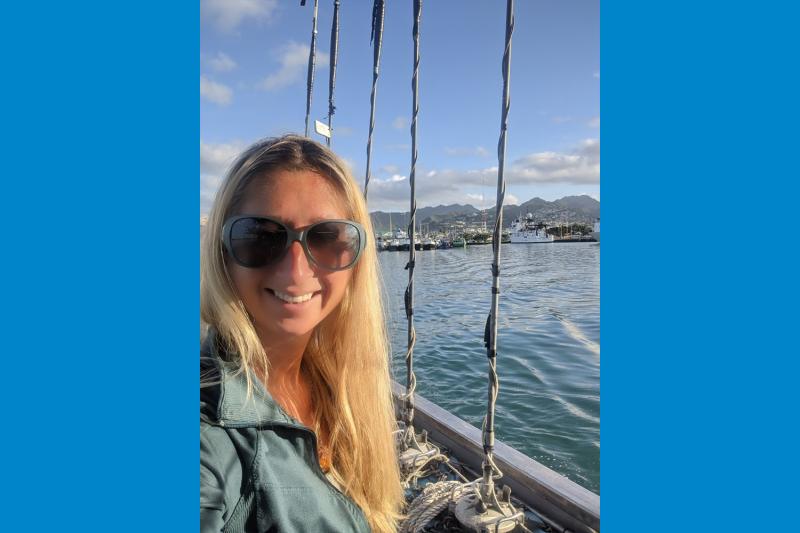 Portrait picture of Jennifer Schultes on a boat and various vessels in the background.