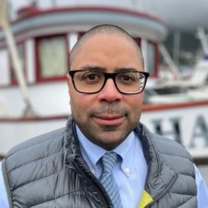 Jamal Moss with a boat in the background.