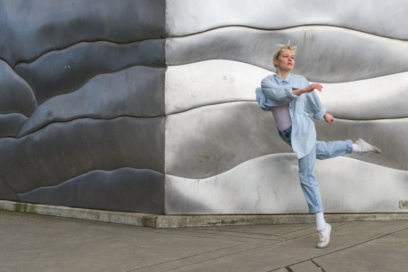 Catherine Ross dancing in front of an outdoor art installation