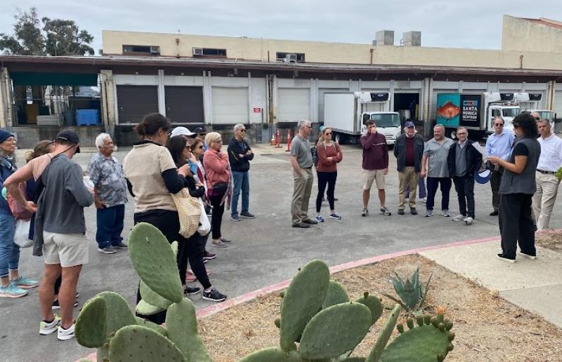 MAFAC members outside of Santa Monica Seafood hearing a talk from Sarah Shoffler (National Seafood Strategy Coordinator, NOAA Fisheries). 