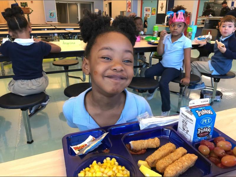 Seafood on a lunch tray with a student from a Greenville County school