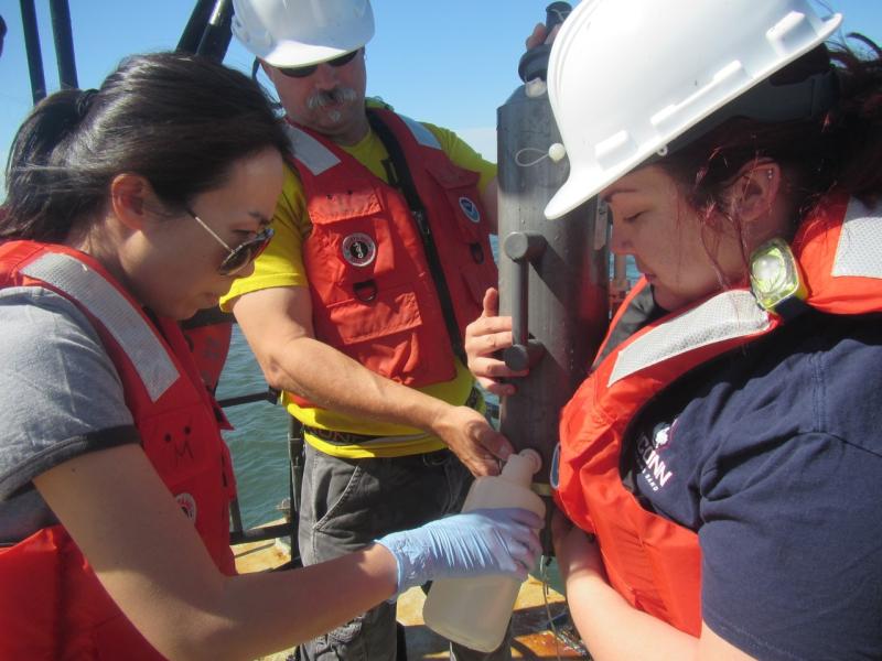 Yuan Liu collecting water samples with colleagues