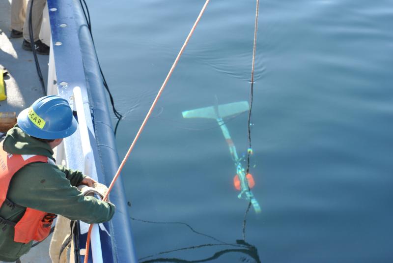 Crew member lowering a towbody. 